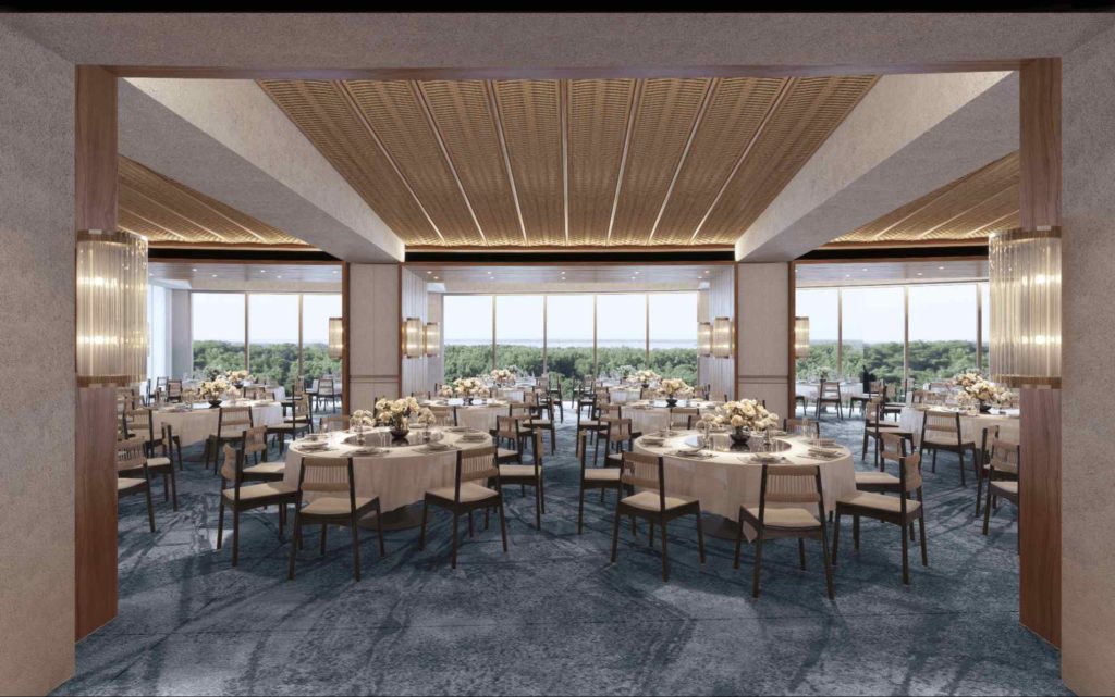 Spacious function room with round dining tables, warm ceiling details, large windows, and scenic greenery views