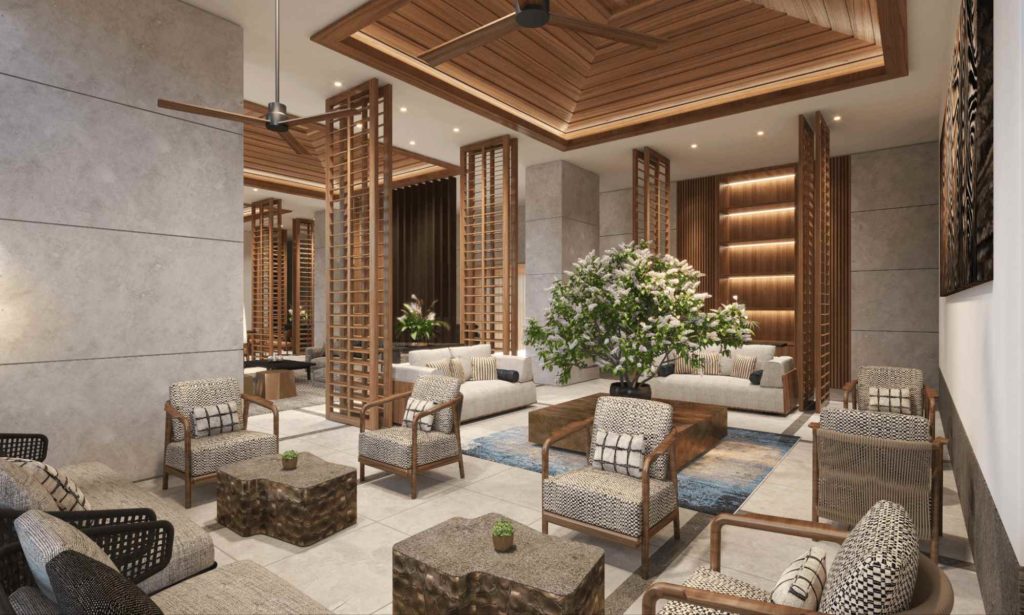 Elegant luxury condominium lounge with wood ceiling details, patterned armchairs, neutral finishes, and indoor greenery