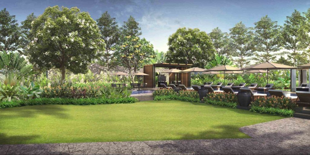 Landscaped garden and poolside lounge area surrounded by trees and lush greenery at a luxury condominium