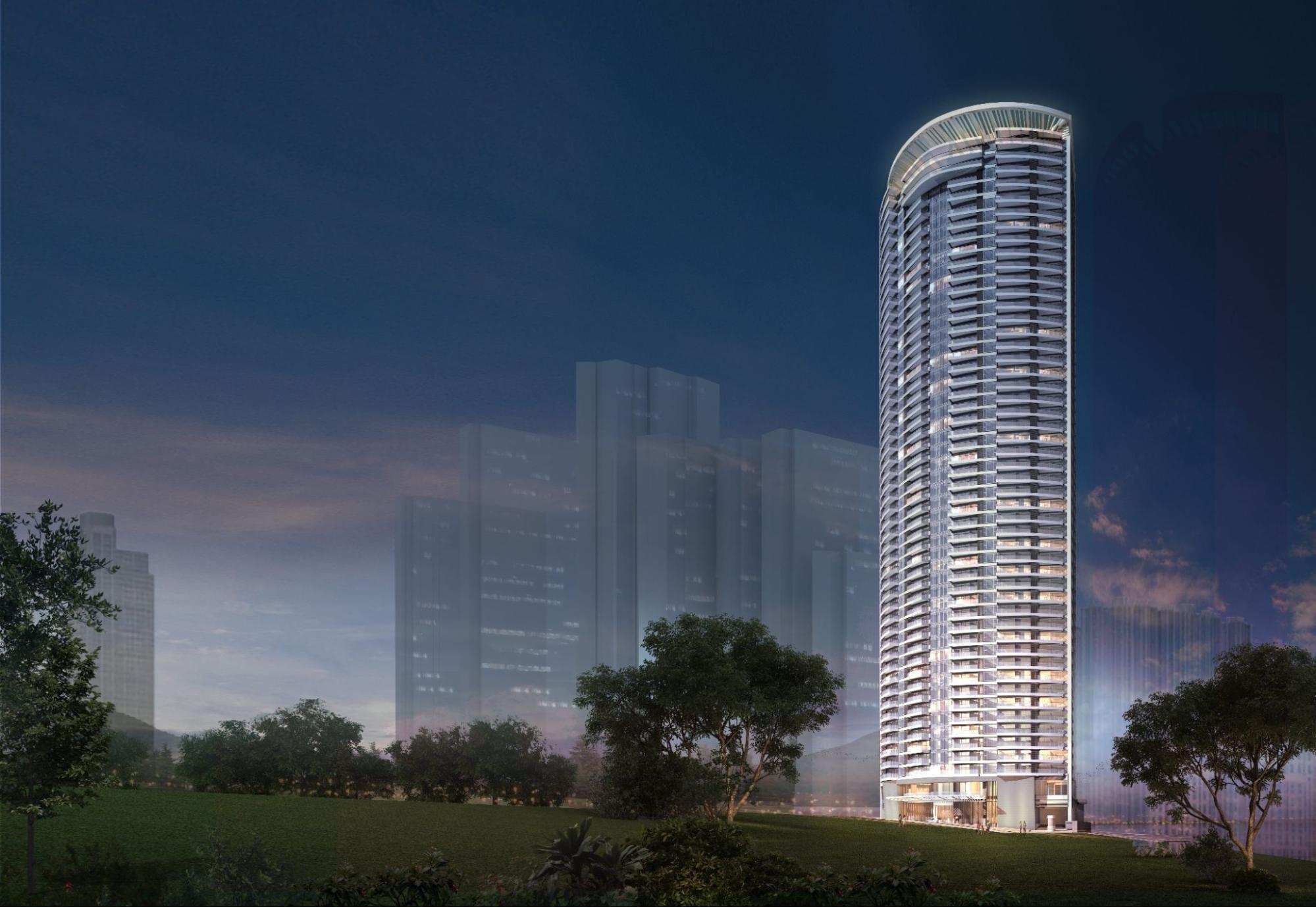 Illuminated luxury condominium tower overlooking greenery and the Metro Manila skyline at dusk
