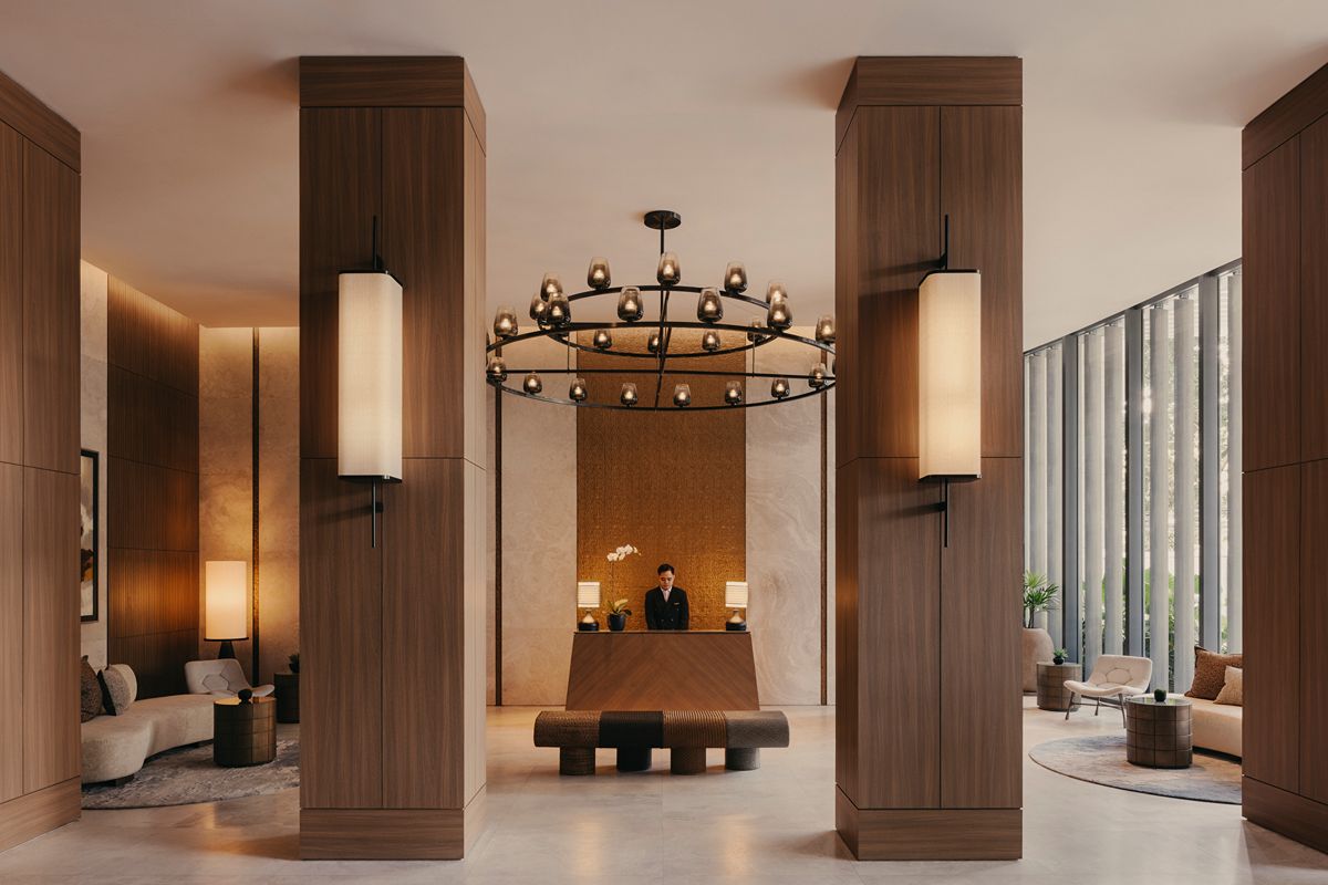 Elegant lobby and reception area at Shang Residences at Wack Wack featuring warm wood finishes, high ceilings, and refined lounge spaces