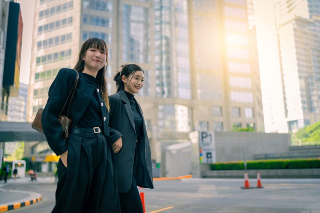 Two professionals walking through a modern business district, highlighting Mandaluyong’s central location near major commercial areas