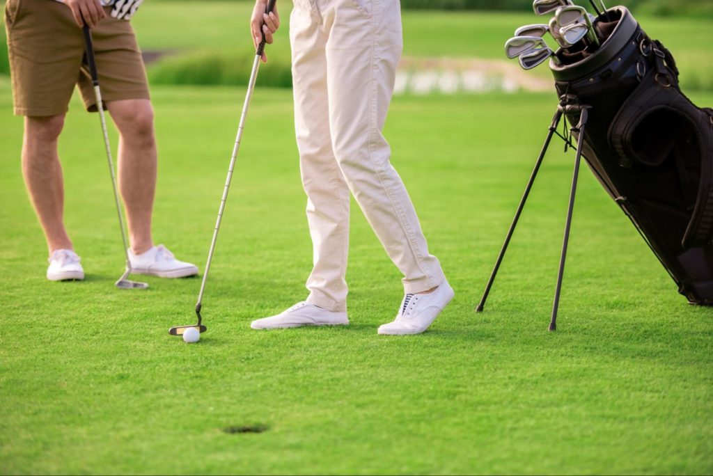 Golfers on a lush green course in Wack Wack, highlighting the open spaces and premium residential setting of Mandaluyong