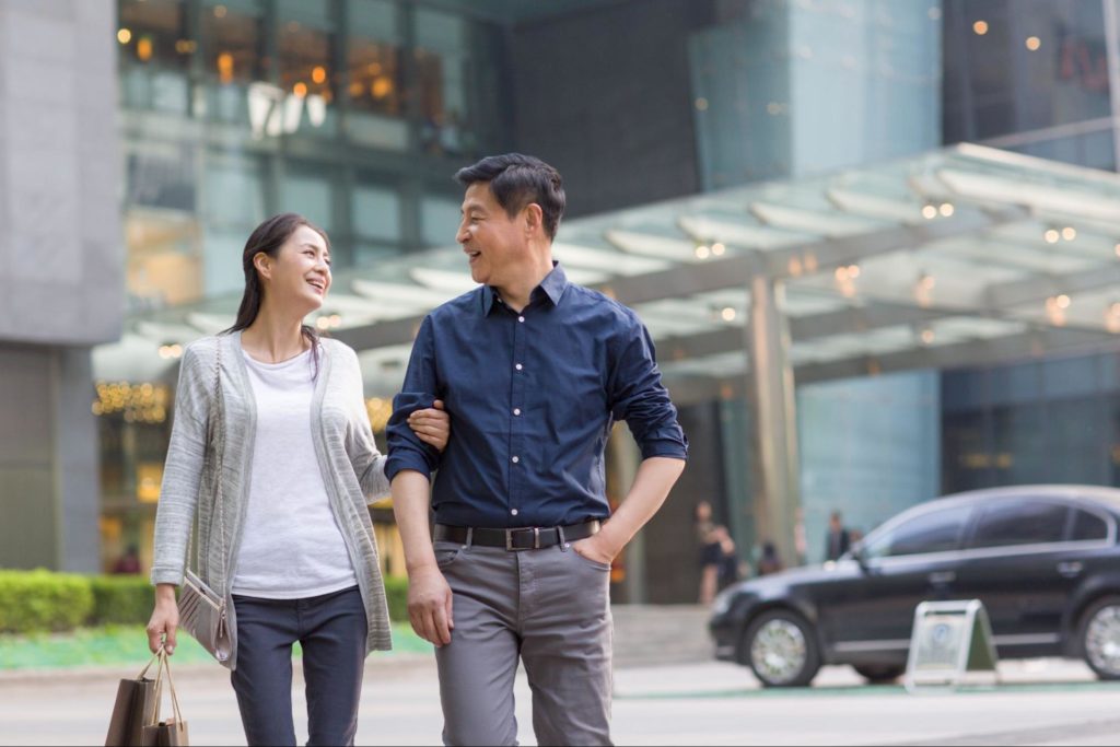Couple walking through a modern urban district in Quezon City, representing convenient access to lifestyle, commercial, and residential destinations