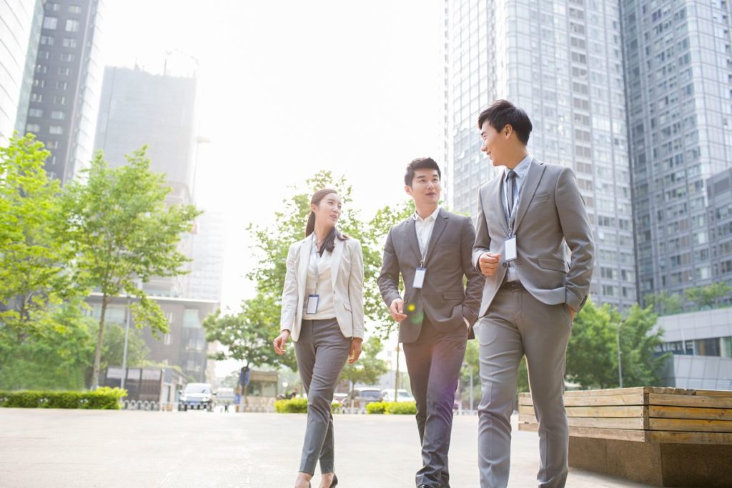 Business professionals walking through Ortigas Center, representing its strong commercial activity and demand for nearby luxury residences