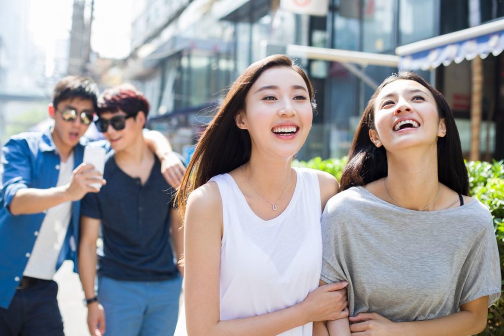 Young professionals walking through Greenfield District, highlighting its modern mixed-use environment and convenient urban lifestyle